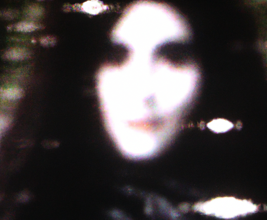 DALL·E-2023-03-30-17.41.06-A-vhs-tape-still-of-an-Alien-who-looks-like-a-woman-with-long-black-hair-small-eyes-grey-skin-fog-sparkles-grainy-blurry-vhs--e1681389362642